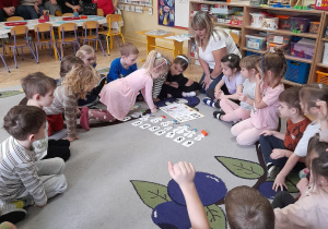 Zdjęcie przedstawia dzieci podczas wykonywania ćwiczeń matematycznych.