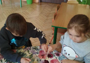 Na tym zdjęciu widać Kubę i Helenkę z grupy IV podczas wykonywania doświadczenia.