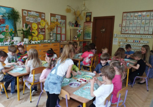 Na tym zdjęciu widać, jak dzieci wykonują bizuterię z koralików.