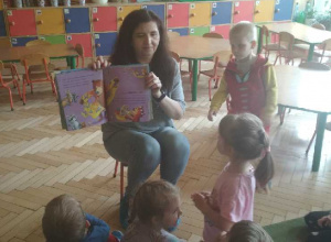 Głośne czytanie przez panią bibliotekarkę