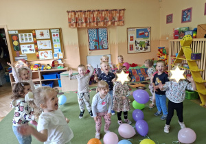 Zdjęcie przedstawia dzieci podczas zabaw z balonikami po odśpiewaniu piosenki.