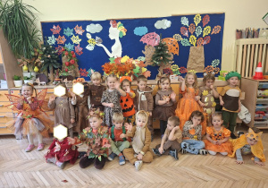 Zdjęcie przedstawia dzieci z grupy I na tle jesiennej dekoracji.