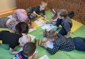 Zdjęcie przedstawia dzieci z grupy III wykonujące kartę pracy "Nasze emocje".