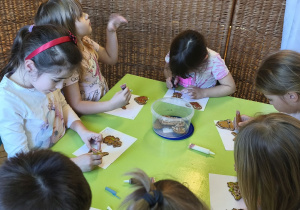 Na tym zdjęciu widać kilkoro dzieci z grupy IV ozdabiających pierniczki.