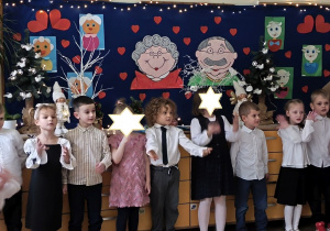 Zdjęcie przedstawia dzieci śpiewające piosenkę z ilustracją ruchową.