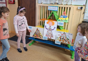 Na tym zdjęciu widać Marcelinkę Ł., która pokazuje swoją pracę oraz pozostałe uczestniczki konkursu.