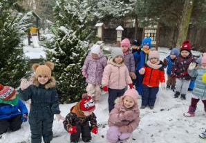 Na tym zdjęciu widać dzieci podczas zimowych zabaw w ogrodzie.
