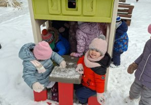 Zdjęcie przedstawia dzieci podczas zimowych zabaw w ogrodzie.