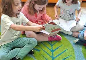 Na tym zdjęciu widać Julka, Klarę P. i Marcelinkę T. z kartami pracy, które otrzymały na warsztatach.