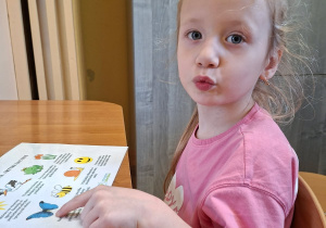 Zdjęcie przedstawia Julę P. z grupy III wykonującą ćwiczenia narządów mowy.