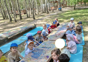 Zdjęcie przedstawia dzieci podczas warsztatów plastycznych.